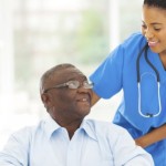 african nurse taking care of senior patient in wheelchair